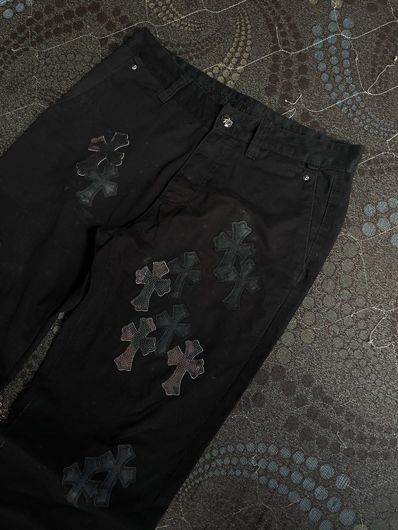 Chrome Hearts Cross Patch Black Pants (Category: Jeans) located in Manila. Submitted by chawmichael (Listing ID 1468880468, Image 3). Description: - Black heavy cotton canvas utility trousers - Detailed with leather cross patches scattered down the front and back - Button fly with custom silver scroll buttons and branded hardware - Rear pockets feature leather piping and a metal scroll logo plate - Straight leg fit for a clean silhouette - Condit