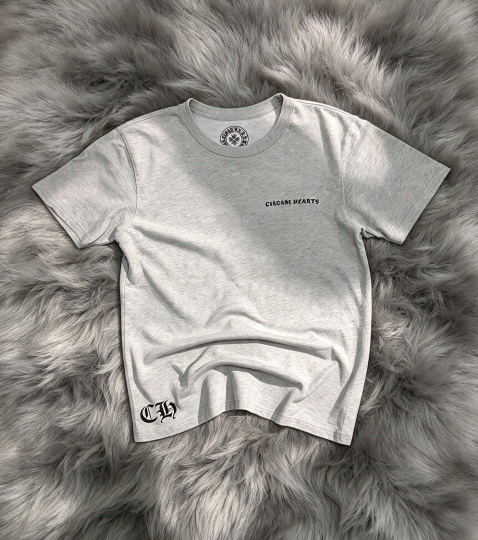 Chrome Hearts x Matty boy (Category: Tshirts & Polo Shirts ) located in Manila. Submitted by i_canthriftyoubetter8 (Listing ID 1468798580, Image 1). Description: - Brand: Chrome Hearts - Color: Grey Heather - Size: M to L - Dimes 21 Width 27 Lenght - Design: Small front chest logo, large cartoon figure/mouth motif and bottle graphic on the back - Details: 'CH' lettering near bottom hem, crew neck, short sleeves - Condition: Clean fabric texture w