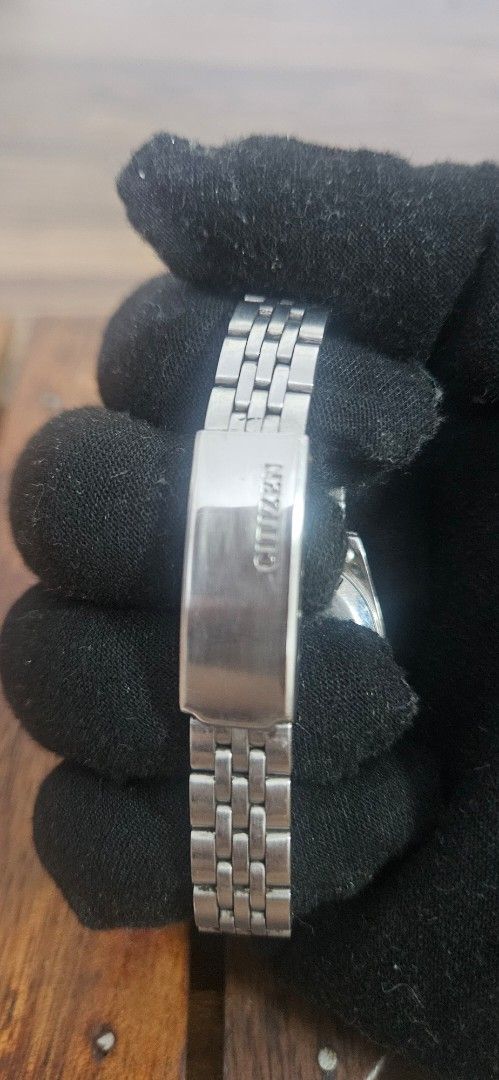 Citizen Automatic 21 Jewels Black Dial Watch (Category: Women's Watches) located in Santa Maria. Submitted by rommelmateo (Listing ID 1468863171, Image 3). Description: - Movement: Automatic with 21 jewels - Dial: Classic black with gold-tone hands and markers - Features: Day-date window at 3 o'clock - Build: Stainless steel case and matching metal link bracelet - Closure: Branded clasp - Crown: Positioned on the right side needs cleaning.