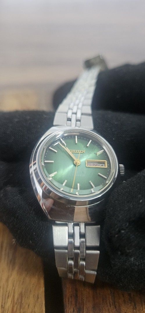 Citizen Vintage Green Dial Automatic Watch (Category: Women's Watches) located in Santa Maria. Submitted by rommelmateo (Listing ID 1468863157, Image 1). Description: - Vintage Citizen automatic watch - Eye-catching vibrant green sunburst dial - Durable stainless steel case and matching bracelet - Convenient day and date window at 3 o'clock - Automatic movement with an exhibition caseback - Iconic Citizen logo-stamped crown - Classic retro design
