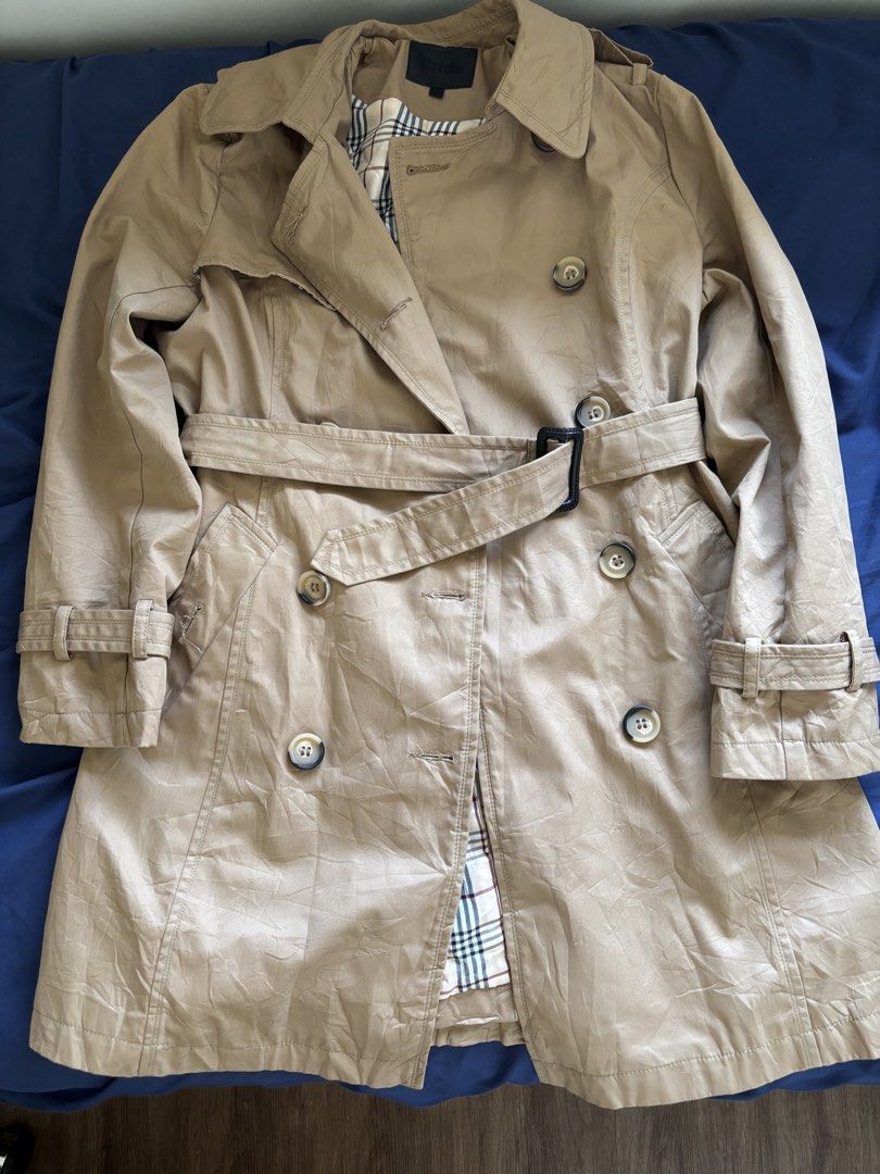 Classic Beige Trench Coat with Checkered Lining (Category: Coats, Jackets and Outerwear) located in Manila. Submitted by prelovedbykleng (Listing ID 1468849258, Image 1). Description: Fits M-L - Color: Classic Beige with traditional plaid check lining - Style: Double-breasted with tortoise shell buttons - Features: Notch lapels, epaulets, and side pockets - Fit & Adjustability: Includes a matching waist belt with black buckle and adjustable wrist