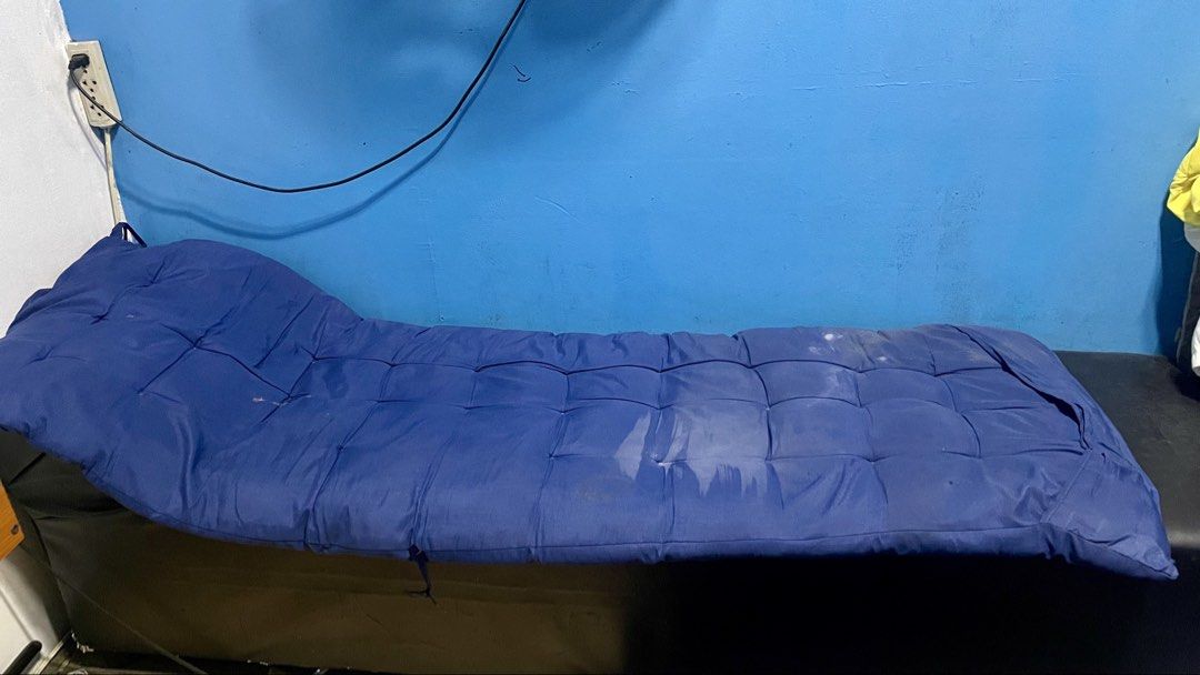 Cleopatra Sofa (Category: Bedding & Towels) located in Taguig. Submitted by peterevangelista213 (Listing ID 1468834458, Image 1). Description: - Item: Blue Quilted Cushion for Lounge or Massage Bed - Design: Tufted surface with built-in elevated headrest for extra comfort - Condition: Pre-loved with some visible white stains on the fabric - Fit: Long rectangular shape, compatible with standard spa and salon furniture - Perfect for budget-consciou