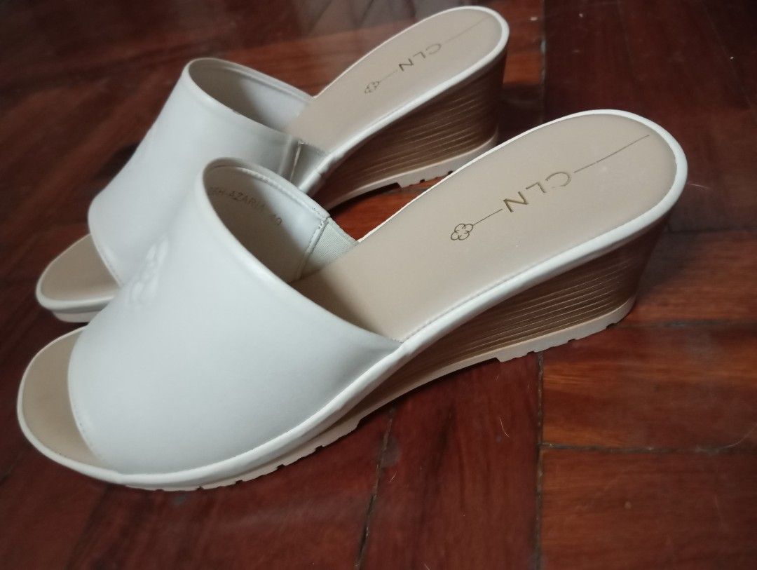 CLN Azaria Wedge Sandals Bone Size 40 (Category: Wedges) located in Caloocan City. Submitted by littlequeenie (Listing ID 1468799800, Image 1). Description: CLN Azaria bone white wedge sandals in size 40. Open toe slip-on style with wide strap across the top. Wood-pattern wedge heel with textured rubber sole. Brand name stamped on the beige insole. Model code 26H-AZARIA printed on the inner strap. condition: like new used once only at wedding.