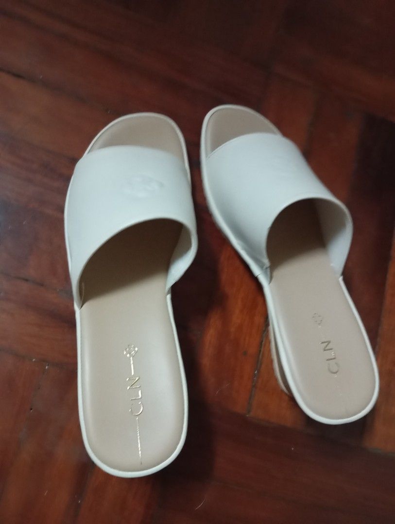 CLN Azaria Wedge Sandals Bone Size 40 (Category: Wedges) located in Caloocan City. Submitted by littlequeenie (Listing ID 1468799800, Image 2). Description: CLN Azaria bone white wedge sandals in size 40. Open toe slip-on style with wide strap across the top. Wood-pattern wedge heel with textured rubber sole. Brand name stamped on the beige insole. Model code 26H-AZARIA printed on the inner strap. condition: like new used once only at wedding.