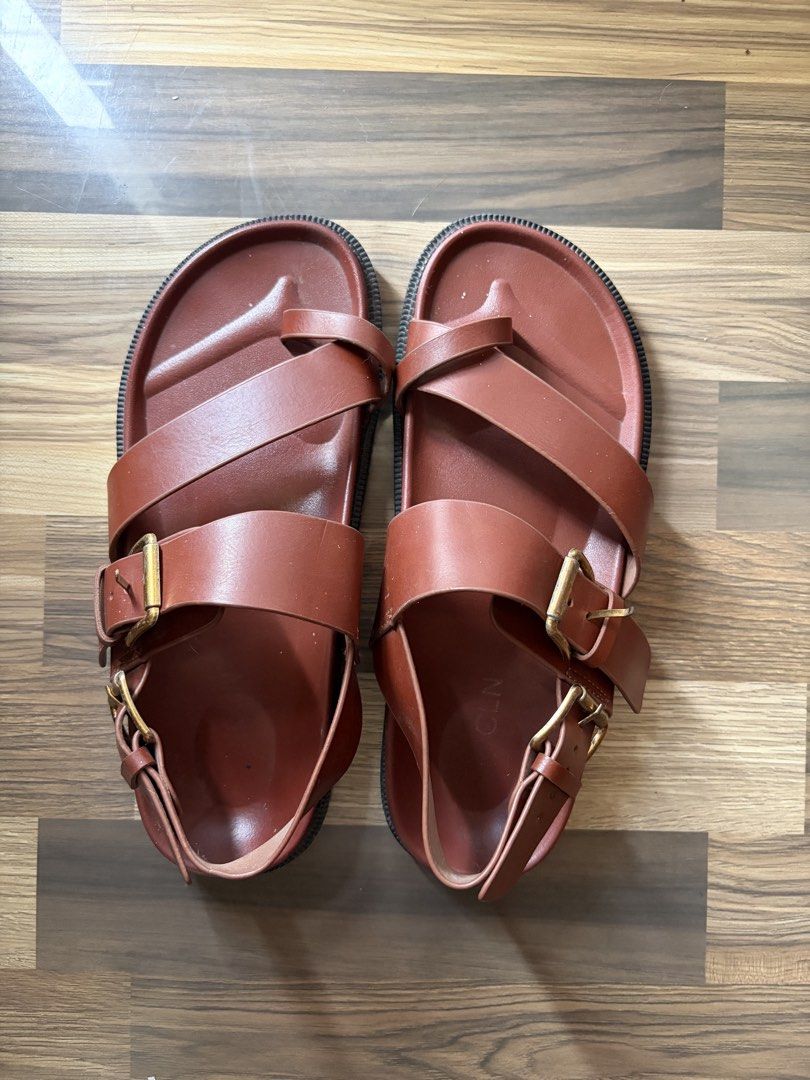 CLN Brown Buckle Sandals (Category: Flats & Sandals) located in Los Banos. Submitted by _bugsssbunny (Listing ID 1468726375, Image 1). Description: - Brand/Style: CLN leather sandals in a rich brown earthy neutral shade - Design: Cross-strap toe loop with adjustable metal pin buckles - Comfort & Sole: Contoured footbed and durable structured lug sole - Condition: Minimal wear visible on the straps and footbed.