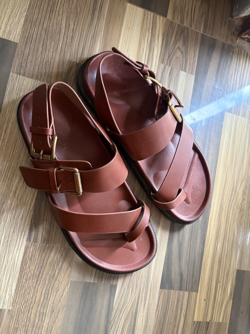 CLN Brown Buckle Sandals (Category: Flats & Sandals) located in Los Banos. Submitted by _bugsssbunny (Listing ID 1468726375, Image 2). Description: - Brand/Style: CLN leather sandals in a rich brown earthy neutral shade - Design: Cross-strap toe loop with adjustable metal pin buckles - Comfort & Sole: Contoured footbed and durable structured lug sole - Condition: Minimal wear visible on the straps and footbed.