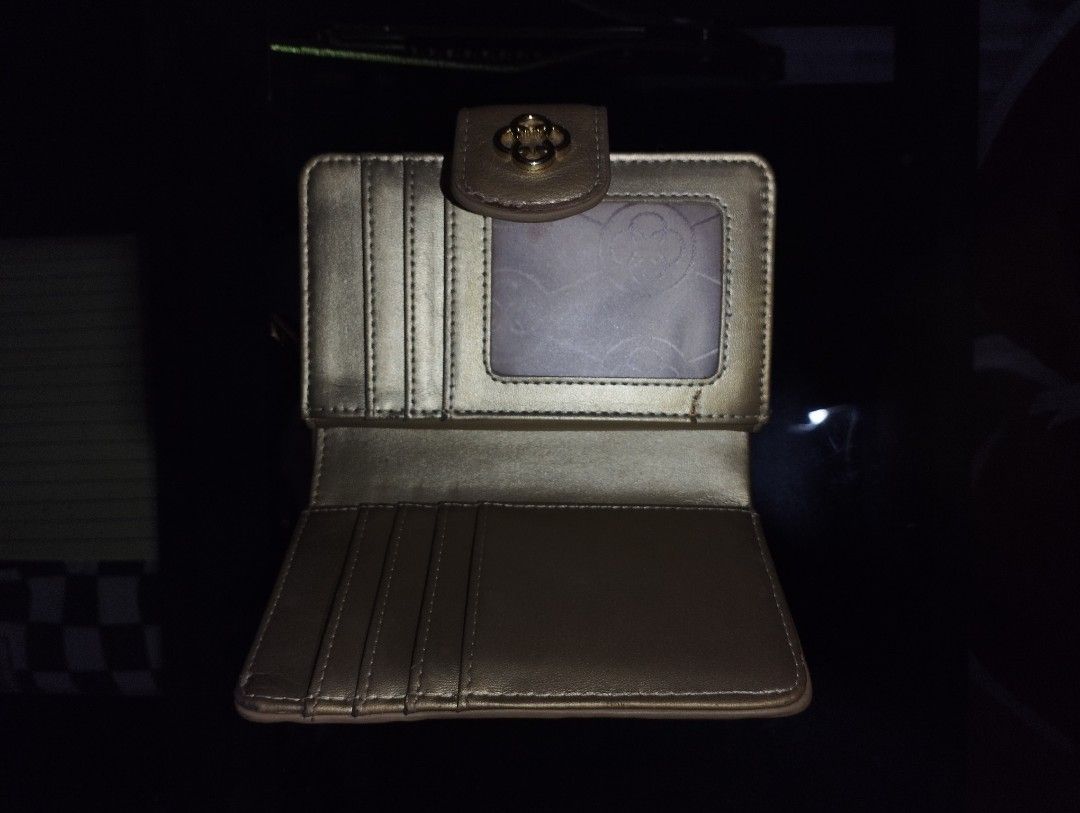 CLN Metallic Gold Patterned Women's Wallet (Category: Wallets & Card holders) located in San Carlos. Submitted by t6kyo (Listing ID 1468807653, Image 3). Description: - Brand: CLN - Color: Metallic gold with debossed patterns and monogram detailing - Closure: Secure magnetic snap on front flap - Interior features: Multiple card slots and an ID window - Condition: Minor edge wear on corners and folds from regular handling - Perfect for daily use o