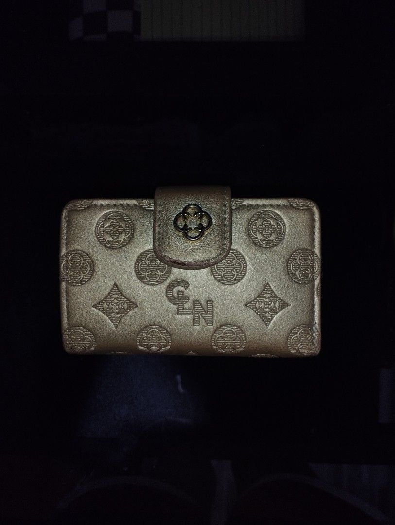 CLN Metallic Gold Patterned Women's Wallet (Category: Wallets & Card holders) located in San Carlos. Submitted by t6kyo (Listing ID 1468807653, Image 1). Description: - Brand: CLN - Color: Metallic gold with debossed patterns and monogram detailing - Closure: Secure magnetic snap on front flap - Interior features: Multiple card slots and an ID window - Condition: Minor edge wear on corners and folds from regular handling - Perfect for daily use o