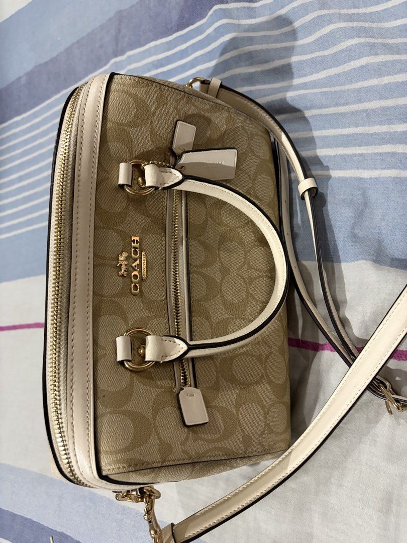 Coach Beige Leather Shoulder Bag with Zipper (Category: Luxury Bags & Wallets) located in Quezon City. Submitted by zeevilqueen (Listing ID 1468793281, Image 1). Description: - Brand: Coach - Color: Classic Beige - Material: Smooth leather with gold-tone hardware - Structure: Structured design with a clean interior - Interior: Brown fabric lining, 1 zippered pocket, and an open compartment partition - Strap: Dual top handles and a detachable shou