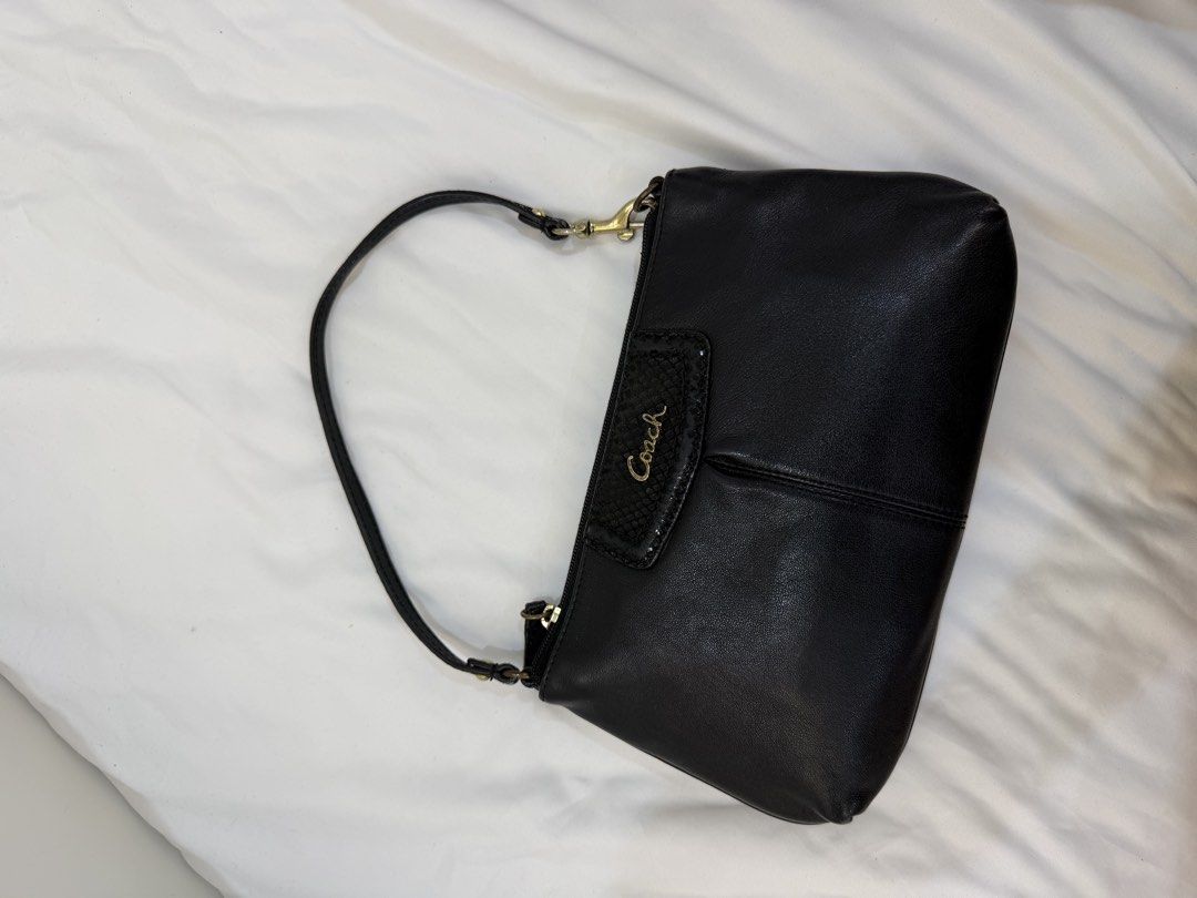 Coach Black Leather bag (Category: Luxury Bags & Wallets) located in Marikina City. Submitted by closet.ar (Listing ID 1468812241, Image 1). Description: - Brand: Coach - Material: Supple black leather with stylish seam detailing - Hardware: Premium gold-toned hardware - Closure: Secure top zipper closure - Strap: Single strap with a secure side clip attachment - Details: Small textured front patch with gold Coach script logo - Condition: Excelle