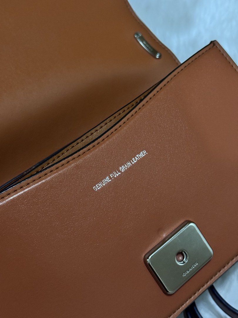 Coach Brown Leather Crossbody Bag (Category: Cross-body Bags) located in Mexico. Submitted by alexacarts (Listing ID 1468850700, Image 3). Description: - Brand: Coach - Style: Crossbody bag - Material: Rich brown leather with full grain leather interior lining - Hardware: Silver-tone with signature C front clasp - Details: Includes matching leather hangtag with horse and carriage emblem - Strap: Adjustable shoulder strap - Compartments: Divided i