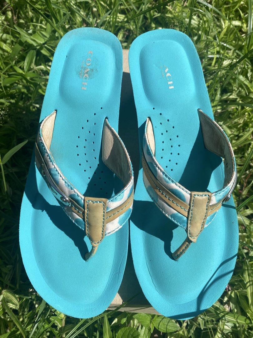 Coach Jaden Blue Wedge Flip Flops Sandals (Category: Wedges) located in Naga. Submitted by foryouandhercloset (Listing ID 1468717700, Image 1). Description: Size 7-8 24 cm Very good condition with signs of usage - Brand: Coach - Style: Wedge flip flops in bright blue - Straps: White and blue polka dot pattern with tan leather trim and metal Coach logo plaque - Footbed: Perforated with stamped Coach logo at the heel - Outsole: Rubber with signatur