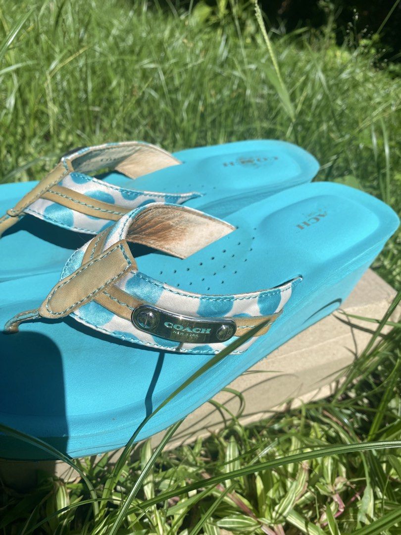 Coach Jaden Blue Wedge Flip Flops Sandals (Category: Wedges) located in Naga. Submitted by foryouandhercloset (Listing ID 1468717700, Image 3). Description: Size 7-8 24 cm Very good condition with signs of usage - Brand: Coach - Style: Wedge flip flops in bright blue - Straps: White and blue polka dot pattern with tan leather trim and metal Coach logo plaque - Footbed: Perforated with stamped Coach logo at the heel - Outsole: Rubber with signatur