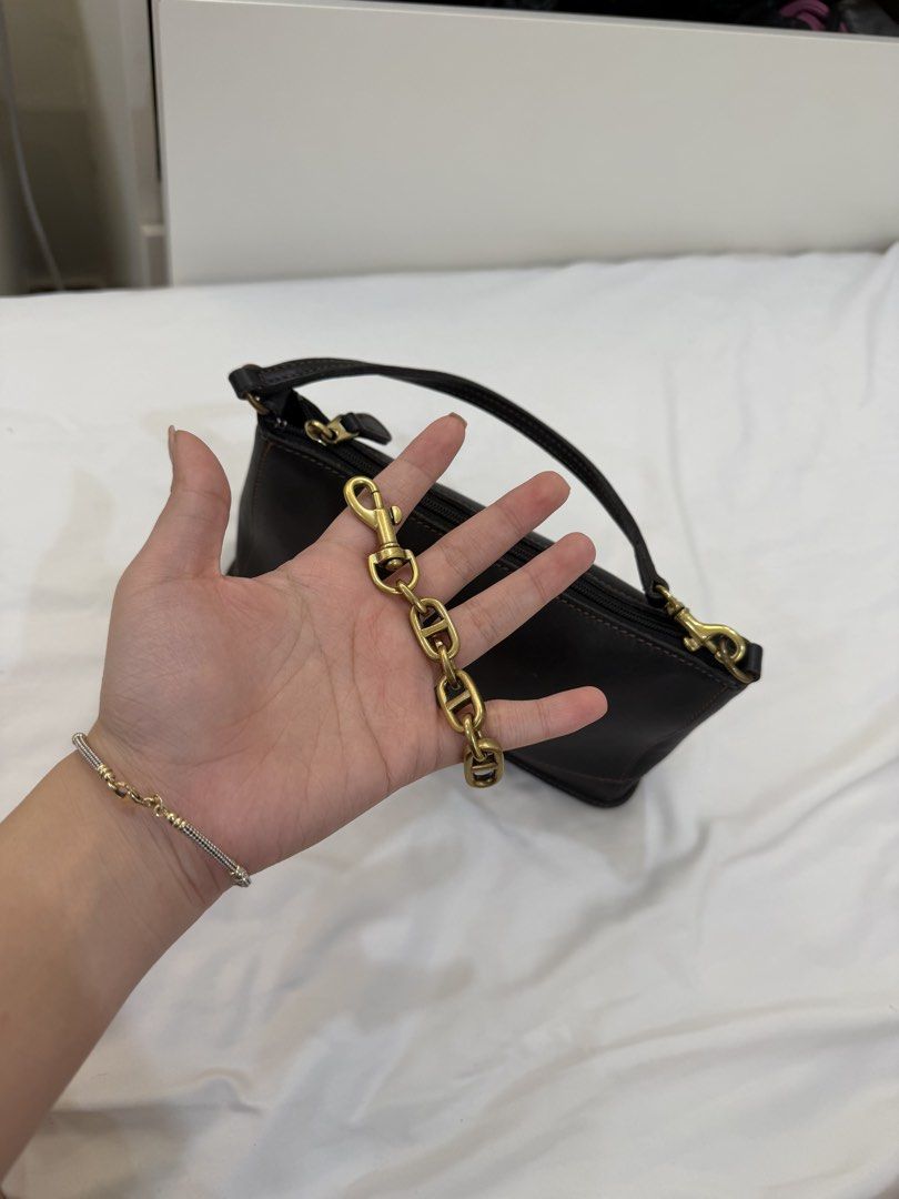 Coach leather bag (Category: Shoulder Bags) located in Marikina City. Submitted by closet.ar (Listing ID 1468812383, Image 2). Description: - Color & Material: black leather with stylish contrast stitching - Closure: Secure top zip - Strap: Detachable antique brass chain strap with lobster clasps - Design: Structured rectangular shape, compact size - Condition: Clean interior lining.