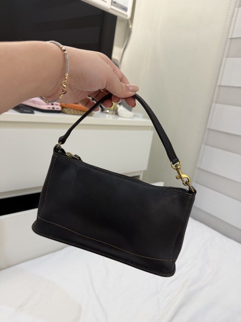 Coach leather bag (Category: Shoulder Bags) located in Marikina City. Submitted by closet.ar (Listing ID 1468812383, Image 1). Description: - Color & Material: black leather with stylish contrast stitching - Closure: Secure top zip - Strap: Detachable antique brass chain strap with lobster clasps - Design: Structured rectangular shape, compact size - Condition: Clean interior lining.