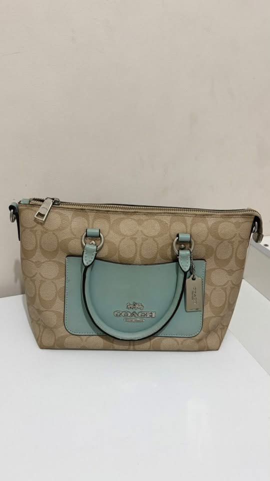 Coach Mini Emma Satchel (Category: Cross-body Bags) located in Manila. Submitted by jln888 (Listing ID 1468757270, Image 1). Description: Coach Mini Emma Satchel Bought in US 🇺🇸 - Authentic Coach Satchel - Signature Canvas with Sea Foam Blue Leather - Top zipper closure - Double handle - Adjustable shoulder straps - Includes Coach Tag - Can be used as a handbag or crossbody bag .