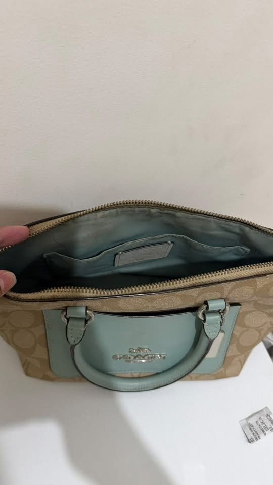Coach Mini Emma Satchel (Category: Cross-body Bags) located in Manila. Submitted by jln888 (Listing ID 1468757270, Image 2). Description: Coach Mini Emma Satchel Bought in US 🇺🇸 - Authentic Coach Satchel - Signature Canvas with Sea Foam Blue Leather - Top zipper closure - Double handle - Adjustable shoulder straps - Includes Coach Tag - Can be used as a handbag or crossbody bag .