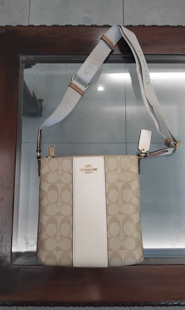 Coach Mini Rowan File Bag CR248 (Category: Cross-body Bags) located in Naga. Submitted by camsss_f (Listing ID 1468744305, Image 2). Description: - Light Khaki / Chalk / Light Saddle - 8.25" (L) x 8.25" (H) x 1.25" (W) - 100% Authentic Coach crossbody bag - Signature monogram canvas with stylish white leather center stripe - Neutral beige and white colorway with gold-tone hardware - Secure zip closure and convenient exterior zip pocket - Adjustab