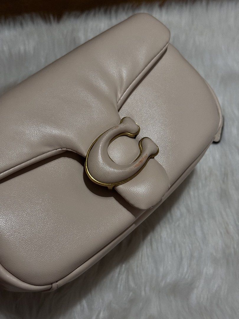 Coach Pillow Tabby Shoulder Bag (Category: Shoulder Bags) located in Mexico. Submitted by itsmealexa (Listing ID 1468851146, Image 1). Description: - Coach Pillow Tabby shoulder bag in neutral beige leather - Structured, puffy silhouette with signature C turnlock closure and gold-tone hardware - Clean interior featuring a divider pocket and leather creed patch (Style C3880) - Short top handle attached for easy carrying - Condition: Gentle wear on