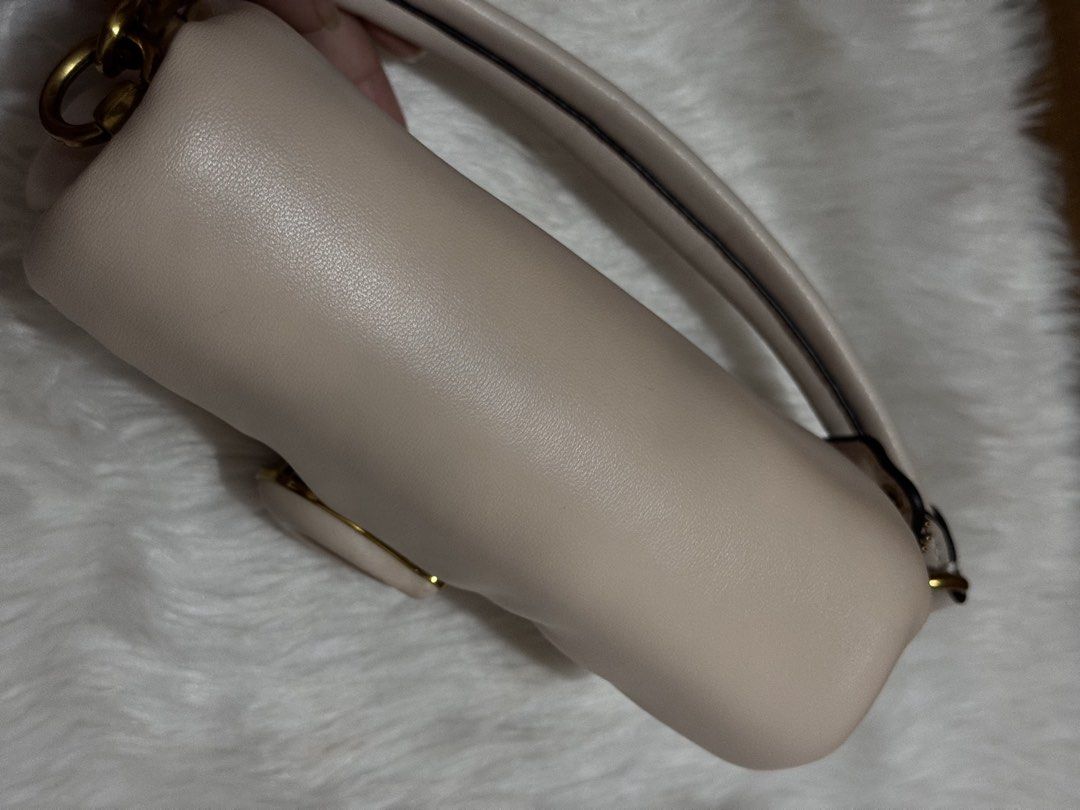 Coach Pillow Tabby Shoulder Bag (Category: Shoulder Bags) located in Mexico. Submitted by itsmealexa (Listing ID 1468851146, Image 3). Description: - Coach Pillow Tabby shoulder bag in neutral beige leather - Structured, puffy silhouette with signature C turnlock closure and gold-tone hardware - Clean interior featuring a divider pocket and leather creed patch (Style C3880) - Short top handle attached for easy carrying - Condition: Gentle wear on