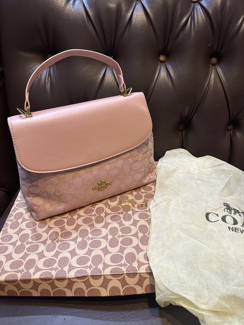 Coach Pink Bag (Category: Luxury Bags & Wallets) located in Manila. Submitted by resecustod09839 (Listing ID 1468840314, Image 1). Description: - Authentic pink Coach top handle handbag in pristine, unused condition - Features signature monogram pattern on the lower half with a solid pink top flap - Elegant gold-tone hardware and iconic gold Coach logo stamp on the front - Medium-sized structured shape with clean, flawless stitching - Comes compl