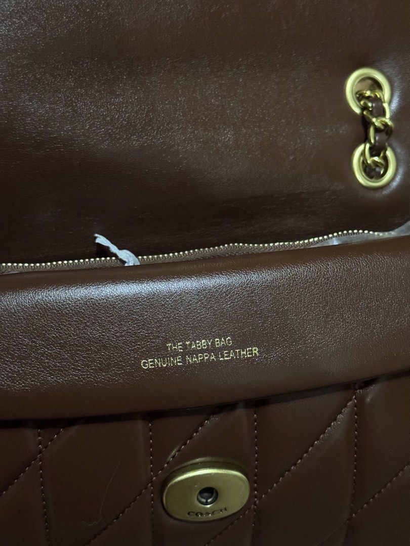 Coach Quilted Nappa Leather Tabby Bag Dark Brown (Category: Luxury Bags & Wallets) located in Mexico. Submitted by itsmealexa (Listing ID 1468852221, Image 2). Description: - Brand: Coach Tabby Shoulder Bag - Color: Dark Brown - Material: Quilted genuine nappa leather with brass hardware and signature C clasp - Strap: Gold-tone chain strap included - Interior: Fabric lining with a secure zip compartment - Condition: Brand new, still stuffed with 