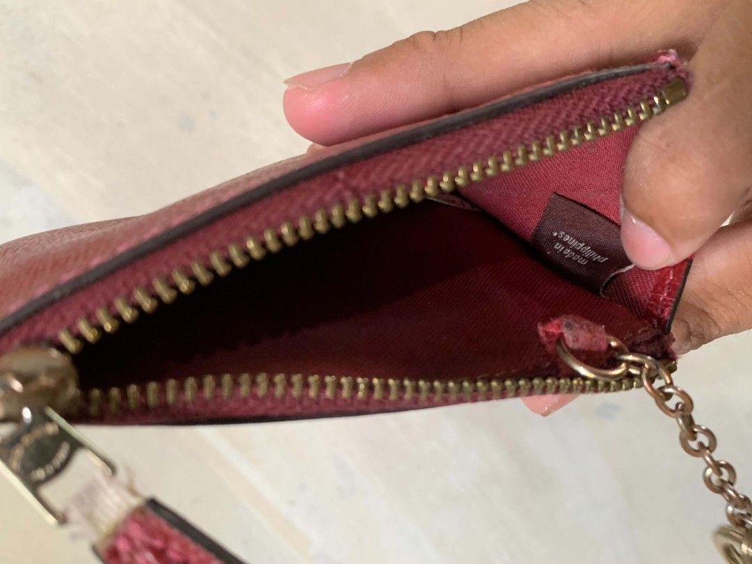 Coach Red Leather Zip Card Case Pouch (Category: Wallets & Card holders) located in Bula. Submitted by wenceslao_aiu (Listing ID 1468788098, Image 3). Description: - Brand: Coach - Material: Red pebbled leather with gold-tone hardware - Style Number: F1878 - Features: Zip closure, attached key ring, and inside chain - Interior: Fabric lining, stamped 'Made in Philippines' - Size: Compact for daily essentials, cards, and keys - Condition: Minor we