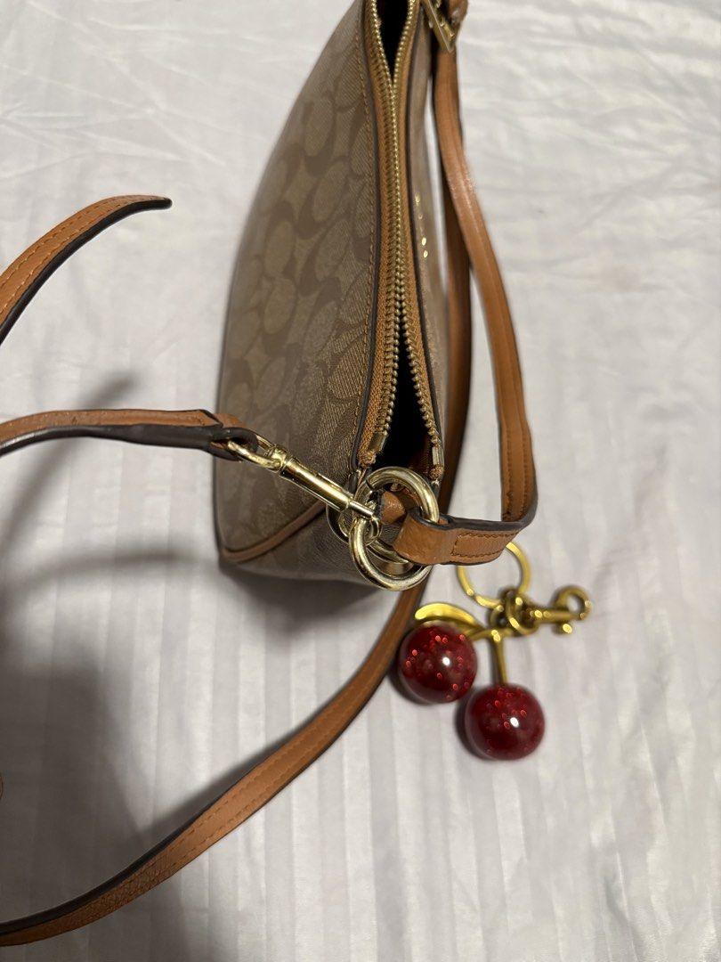 COACH Shoulder/Sling Bag (Category: Cross-body Bags) located in Manila. Submitted by karizetto (Listing ID 1468866865, Image 2). Description: NGA check pics thoroughly with free CHERRY KEYCHAIN hindi na maalis yung amoy storage/cabinet ng bag .