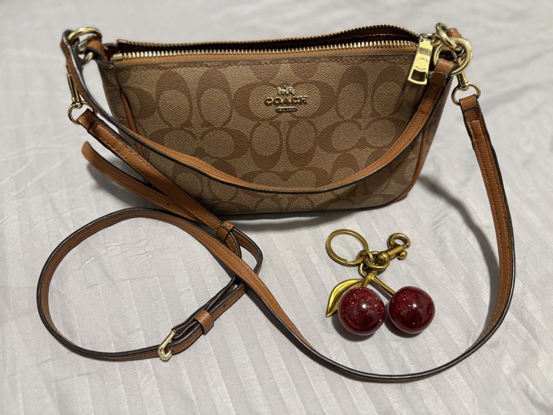 COACH Shoulder/Sling Bag (Category: Cross-body Bags) located in Manila. Submitted by karizetto (Listing ID 1468866865, Image 1). Description: NGA check pics thoroughly with free CHERRY KEYCHAIN hindi na maalis yung amoy storage/cabinet ng bag .