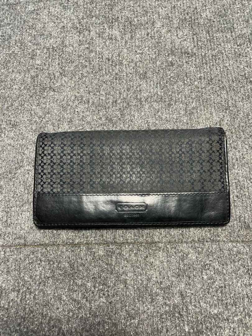 Coach Signature Black Long Wallet (Category: Wallets & Card holders) located in Ligao. Submitted by merjudioma64633 (Listing ID 1468748159, Image 1). Description: - Authentic Black Coach Long Wallet - Material: Signature patterned canvas and leather - Closure: Flap with debossed Coach logo plate - Interior: Multiple card slots, slip compartments, and a secure zippered pocket - Condition: Shows minor signs of wear on inner lining edges and zip pul
