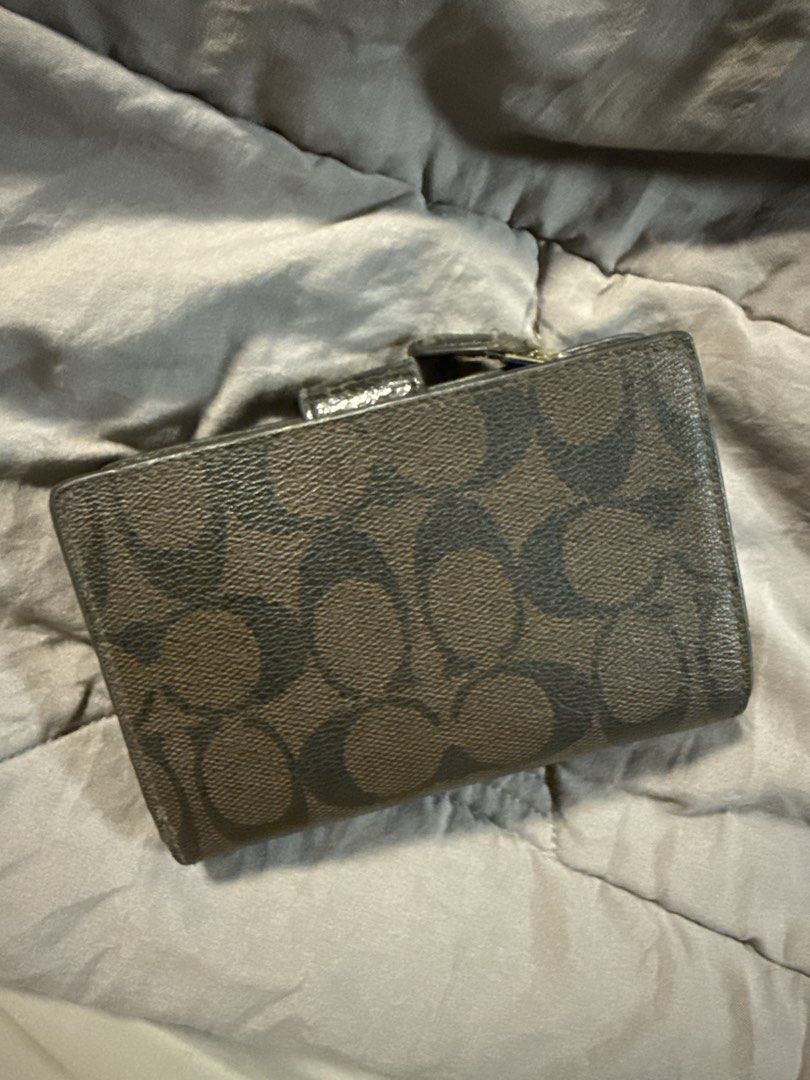 Coach Signature Brown Medium Snap Wallet (Category: Luxury Bags & Wallets) located in Caloocan City. Submitted by tootsief (Listing ID 1468878008, Image 2). Description: - Authentic Coach medium bi-fold wallet - Classic brown signature monogram canvas with gold-tone hardware - Front snap closure tab with Coach New York lettering - Multiple card slots and cash compartments inside - Compact and sturdy design, perfect for everyday use - Fits easily 