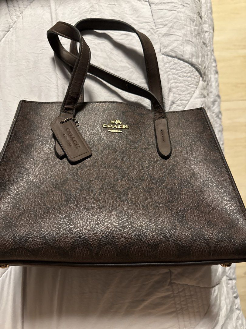Coach Signature Monogram Brown Tote Bag (Category: Luxury Bags & Wallets) located in Caloocan City. Submitted by tootsief (Listing ID 1468864451, Image 1). Description: - Brand: Coach - Design: Classic brown signature monogram coated canvas - Straps & Trim: Dark brown leather double shoulder straps - Hardware: Gold tone with matching Coach hangtag and front gold foil embossed logo - Structure: Flat structured bottom profile - Interior: Clean comp