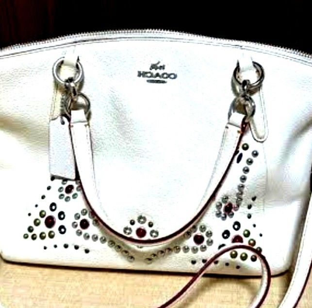 Coach White Leather Studded Handbag with Shoulder Strap (Category: Cross-body Bags) located in Manila. Submitted by lene48 (Listing ID 1468776194, Image 2). Description: - Brand: Coach - Color: White with colorful studs and metallic embellishments - Material: Premium pebbled leather - Hardware: Silver-tone - Closure: Secure top zipper - Carry Options: Dual top handles and a detachable matching shoulder strap - Includes: Original leather hangtag.
