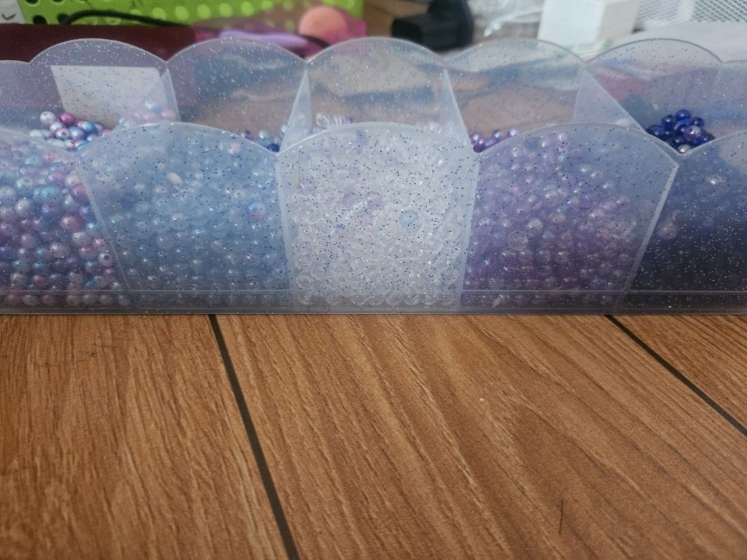 Colorful craft beads (Category: Craft Supplies & Tools) located in Valenzuela. Submitted by marionroseee (Listing ID 1468731519, Image 2). Description: - take all - small round beads, bought too many or the taylor swift concert before - Colors: Deep navy, purple, clear, light blue, and iridescent pink-blue mix - Use for DIY jewelry making, friendship bracelets, and crafts .
