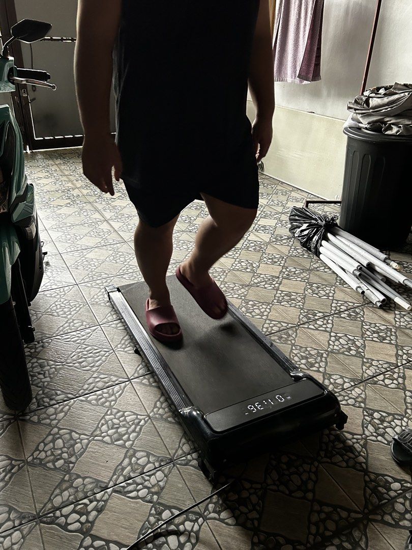 Compact Under Desk Walking Pad Treadmill with Remote (Category: Cardio & Fitness Machines) located in Bulacan. Submitted by jseongcart_ (Listing ID 1468808387, Image 2). Description: Conditions: - Can hold up to 150kg weight - Used x3 only - Rfs: decluttering ----------- - Type: Compact walking pad treadmill - Color: Sleek black - Condition: Tested and working properly - Features: Digital display (tracks speed and distance) and handheld remote co