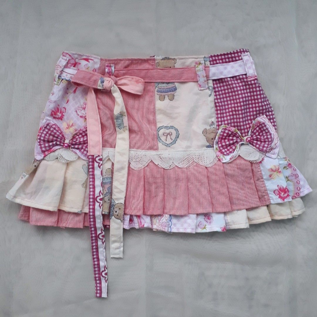 Coquette Pink Patchwork Pleated Mini Skirt (Category: Skirts) located in Cabanatuan. Submitted by madeby_csnstudio (Listing ID 1468730056, Image 1). Description: MEASUREMENTS: Waist: 30 inches (76.2 cm) Hips: 37 inches (93.98 cm) Length: 13 inches (33.02 cm) DETAILS: The design combines soft pink florals, classic pink gingham, micro-stripes, and teddy bear illustrations. It features built-in belt loops along the waistband with matching patchwork 