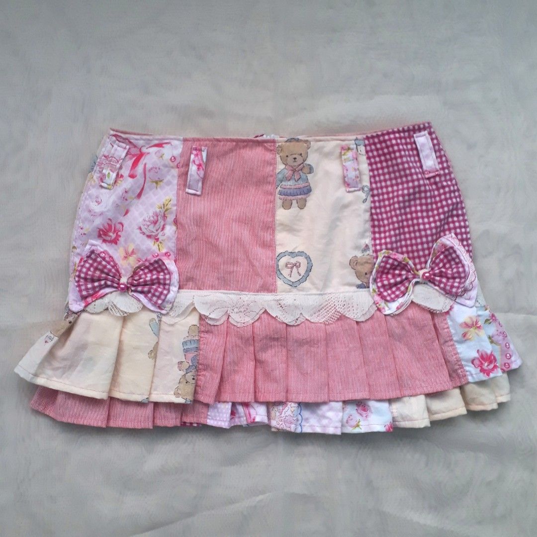 Coquette Pink Patchwork Pleated Mini Skirt (Category: Skirts) located in Cabanatuan. Submitted by madeby_csnstudio (Listing ID 1468730056, Image 2). Description: MEASUREMENTS: Waist: 30 inches (76.2 cm) Hips: 37 inches (93.98 cm) Length: 13 inches (33.02 cm) DETAILS: The design combines soft pink florals, classic pink gingham, micro-stripes, and teddy bear illustrations. It features built-in belt loops along the waistband with matching patchwork 
