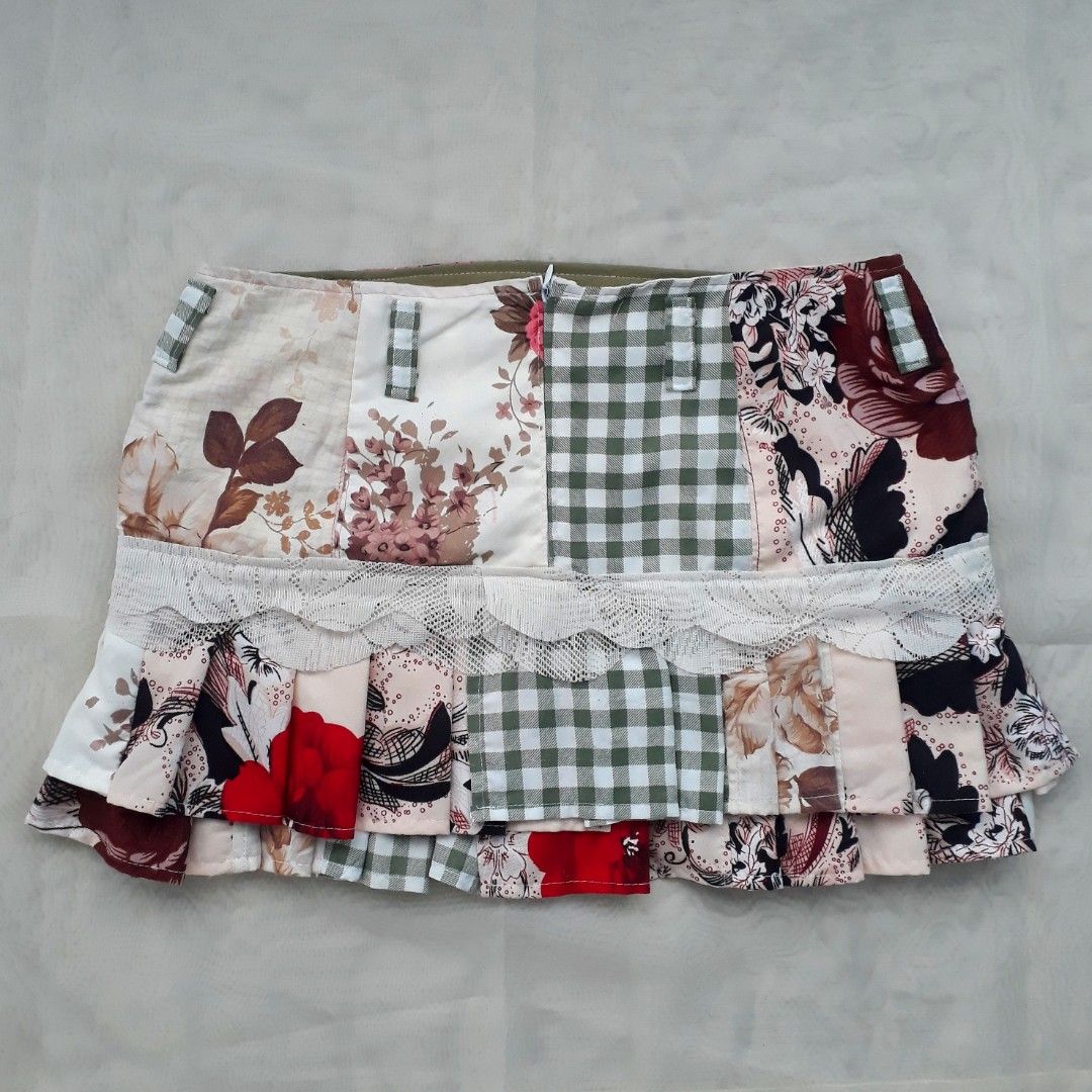 Cottagecore Patchwork Pleated Mini Skirt (Category: Skirts) located in Cabanatuan. Submitted by madeby_csnstudio (Listing ID 1468728487, Image 3). Description: MEASUREMENTS: Waist: 30 inches (76.2 cm) Hips: 37 inches (93.98 cm) Length: 13 inches (33.02 cm) DETAILS: The multi-fabric layout features a combination of sage gingham checks, delicate pink gingham, vintage rose floral prints, and subtle graphic accents. Built-in belt loops outline the wa