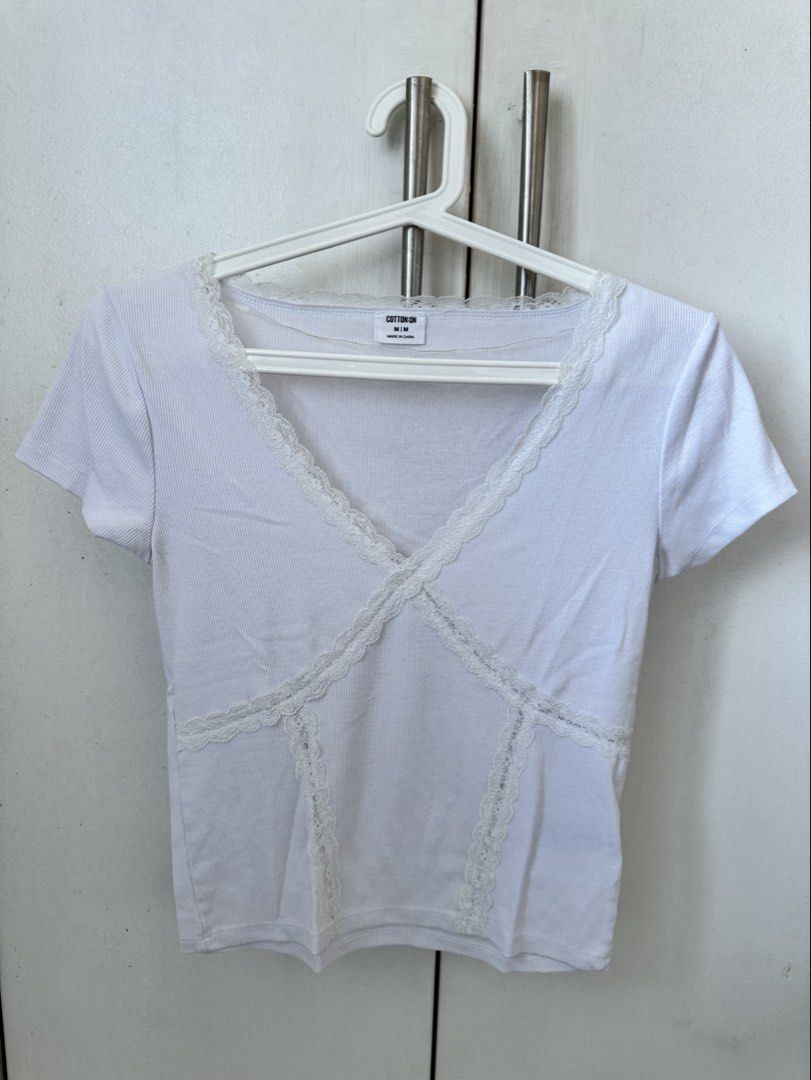 Cotton On White Lace Trim Tee Size M (Category: Shirts) located in Manila. Submitted by secondguess (Listing ID 1468842233, Image 1). Description: - Brand: Cotton On - Size: M (tag intact) - Color: Crisp White - Material: Comfortable ribbed cotton - Details: V-neckline and front seams with delicate lace trim - Condition: Clean and well-maintained - Style: Versatile basic, easy to pair with jeans or skirts RFS: only used ONCE 🥲 not my style anymo