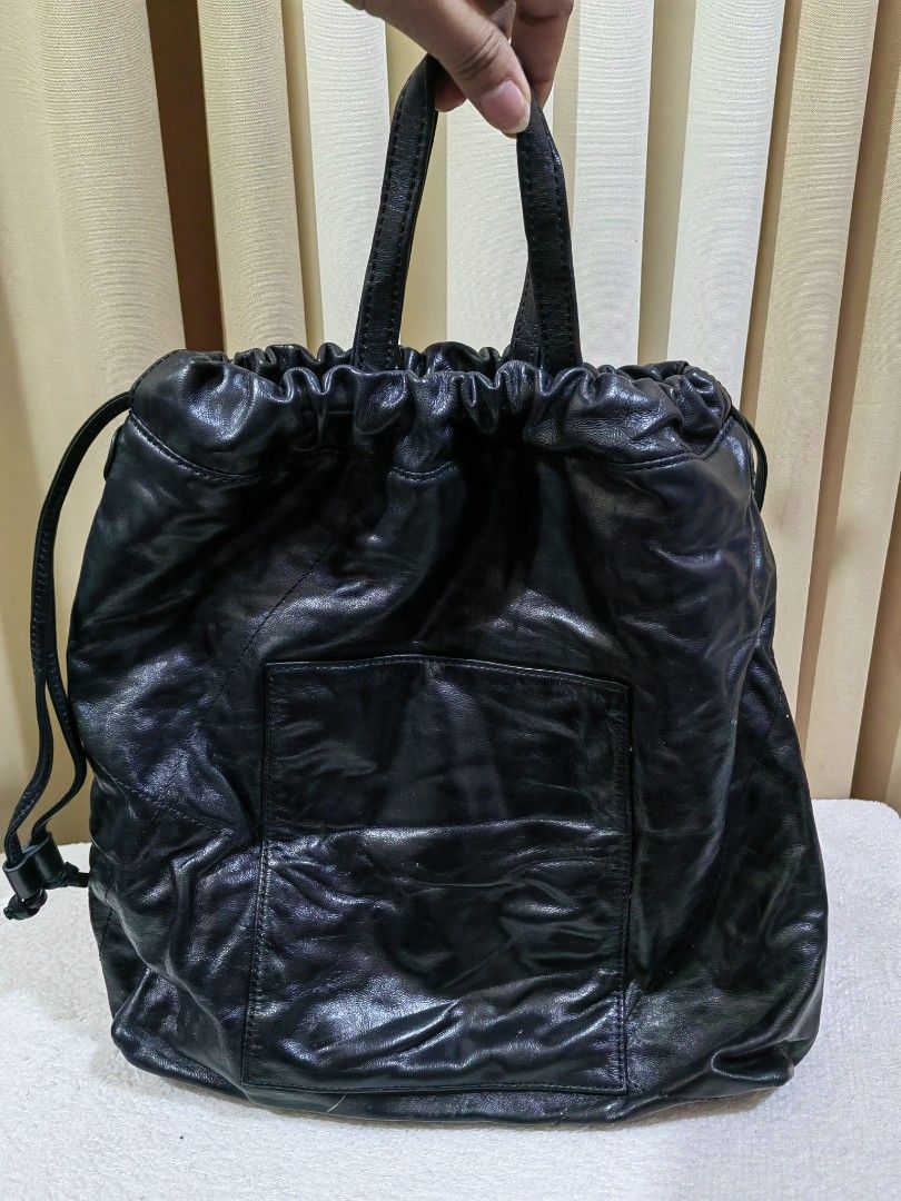 Couronne Black Leather Drawstring Bucket Bag (Category: Cross-body Bags) located in Makati City. Submitted by prelovedtreatedwithlove (Listing ID 1468893400, Image 3). Description: - Brand: Couronne - Material: Soft, black leather - Closure: Secure drawstring top with a gathered look - Style : 2 way with YKk zip - Condition : Excellent A-174.