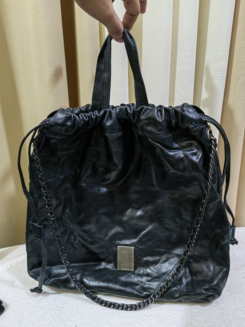 Couronne Black Leather Drawstring Bucket Bag (Category: Cross-body Bags) located in Makati City. Submitted by prelovedtreatedwithlove (Listing ID 1468893400, Image 2). Description: - Brand: Couronne - Material: Soft, black leather - Closure: Secure drawstring top with a gathered look - Style : 2 way with YKk zip - Condition : Excellent A-174.