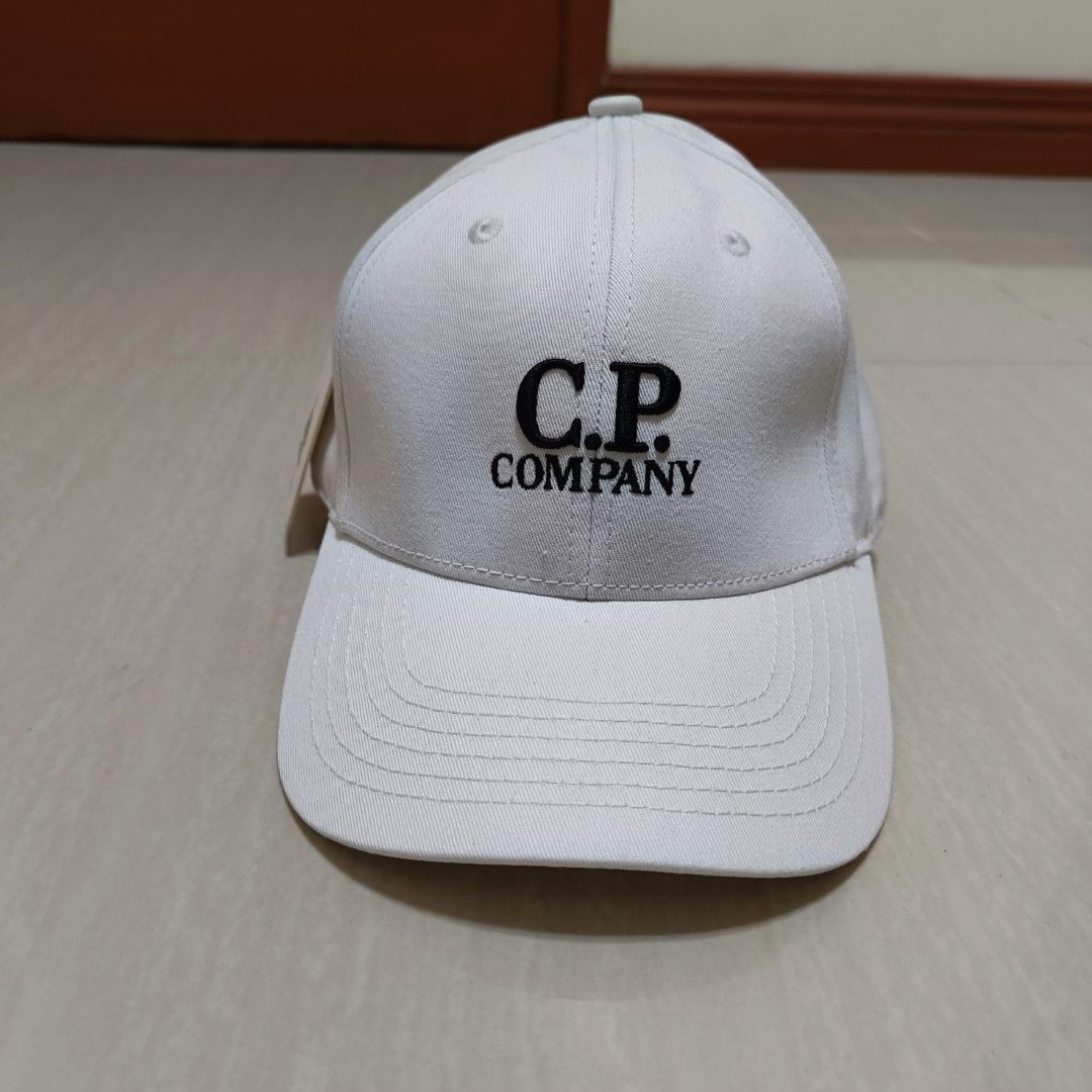 C.P. Company Cap Embroidery Adjustable Back (Category: Caps & Hats) located in Nasugbu. Submitted by staffpicks1515 (Listing ID 1468793627, Image 2). Description: - Brand: C.P. Company - Color: White - Details: Embroidered black logo on front and matching embroidery on back - Hardware: Adjustable strap with metal buckle (embossed branding) - Interior: Branded taping and tags - Condition: Brand new with original hangtag attached.