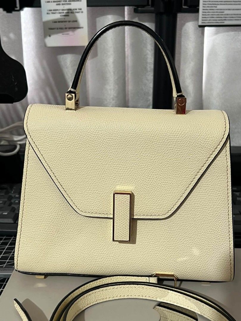 Cream Top Handle Bag with Shoulder Strap (Category: Luxury Bags & Wallets) located in Manila. Submitted by boldfire_315559 (Listing ID 1468798527, Image 1). Description: - Color/Finish: Cream structured textured leather with contrasting black trim - Hardware: Premium gold-toned hardware with a secure front flap closure and rectangular metal clasp - Versatility: Includes a single top handle and a removable, adjustable matching shoulder strap - Pro