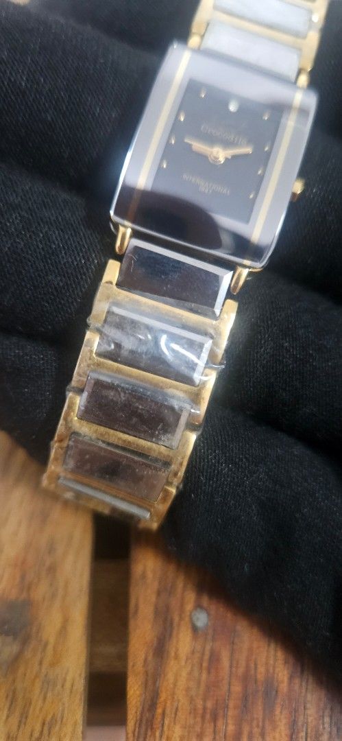 Crocodile International gold tone rectangle watch (Category: Women's Watches) located in Santa Maria. Submitted by rommelmateo (Listing ID 1468859619, Image 2). Description: - Brand: Crocodile International - Style: Gold-tone watch with a sleek rectangular dark dial and gold hands - Case: Gold case with elegant curved sides - Strap: Bracelet strap with alternating links, still wrapped in original protective plastic - Closure: Secure fold-over cla