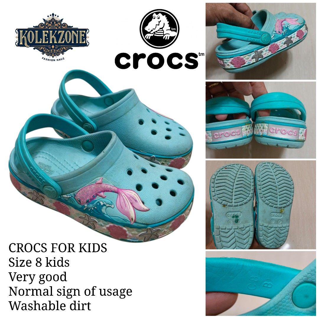 Crocs Kids Mermaid Clogs Size 8 Turquoise (Category: Babies & Kids Fashion) located in Nasugbu. Submitted by staffpicks1515 (Listing ID 1468792240, Image 1). Description: - Brand/Item: Kids' Crocs Clogs - Size: 8 - Color: Turquoise - Design: Fun mermaid tail on the side with seashell and starfish graphics - Condition: Normal signs of wear (only washable dirt) - Features: Easy slip-on design, perfect for everyday play.
