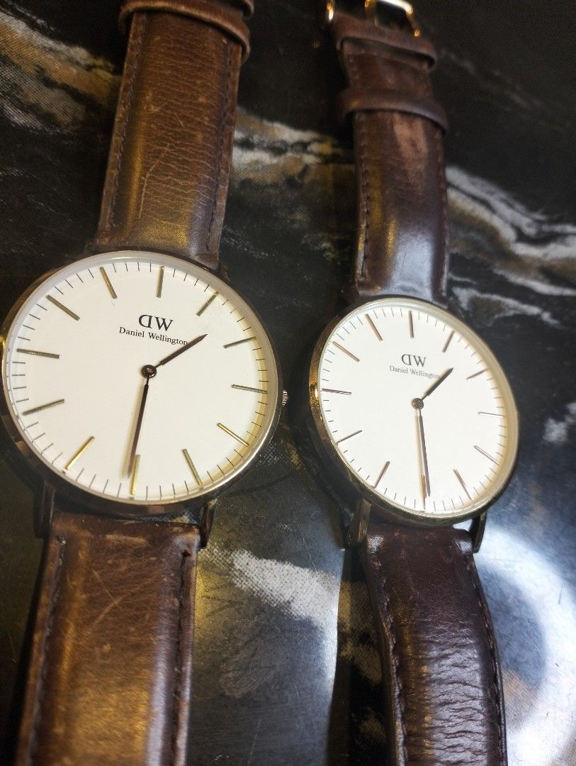 Daniel Wellington Classic Watch Set (Category: Men's Watches) located in General Mariano Alvarez. Submitted by ma.miafajardo1219 (Listing ID 1468925720, Image 2). Description: Two Daniel Wellington watches .2500 esch White dials, rose gold tone cases, genuine leather brown straps showing plenty of wear and creasing. Japanese quartz movement, 3ATM water resistant. One serial number 0117003535, second serial number 01030813338. Classic minimalist r