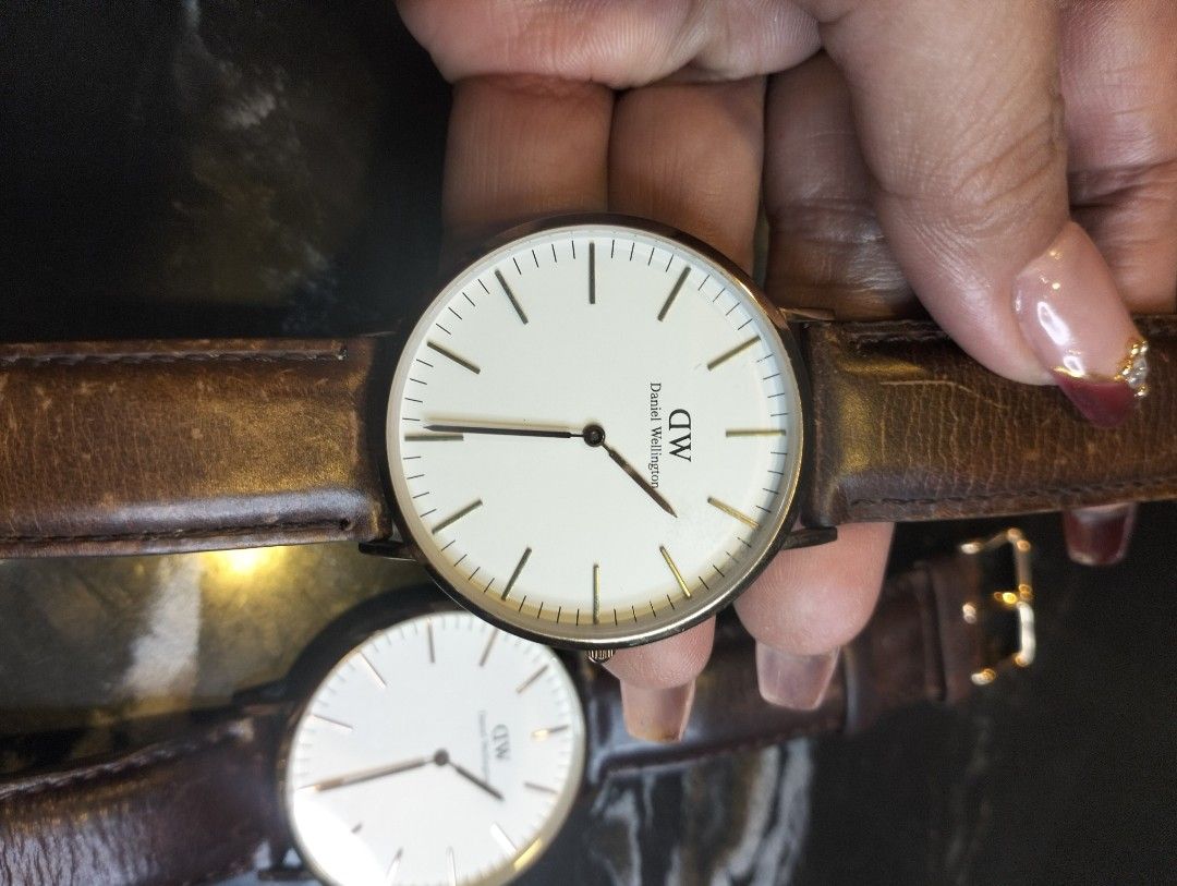 Daniel Wellington Classic Watch Set (Category: Men's Watches) located in General Mariano Alvarez. Submitted by ma.miafajardo1219 (Listing ID 1468925720, Image 3). Description: Two Daniel Wellington watches .2500 esch White dials, rose gold tone cases, genuine leather brown straps showing plenty of wear and creasing. Japanese quartz movement, 3ATM water resistant. One serial number 0117003535, second serial number 01030813338. Classic minimalist r