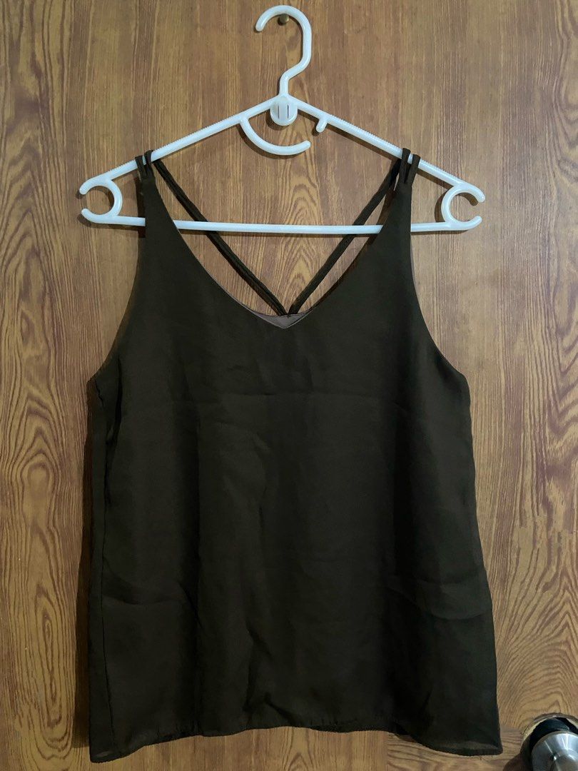 Dark Brown Cami Tank Top with Cross Straps (Category: Sleeveless) located in Caloocan City. Submitted by lovedbyryu (Listing ID 1468845394, Image 1). Description: - Color: Dark brown - Style: Sleeveless cami top with V-neck and unique criss-cross thin straps - Fabric: Lightweight with a slightly sheer bottom hem - Versatility: Perfect for layering or wearing alone on warm days - Condition: Excellent, clean fabric with no stains or damage.