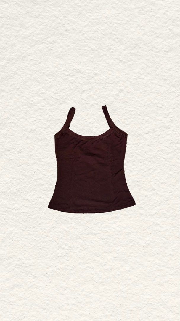 Dark brown scoop neck tank top cami basic (Category: Sleeveless) located in Quezon City. Submitted by zealhorse_a9f3c3 (Listing ID 1468797997, Image 1). Description: - Color: Dark brown - Design: Scoop neckline with thick straps and a slightly flared hem - Fit: Soft, stretchy fabric that hugs the body nicely - Versatility: Great everyday basic for layering or wearing solo - Styling: Easy to match with jeans, skirts, or shorts.