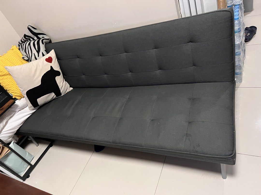 Dark Grey Tufted Sofa Bed (Category: Sofas) located in Manila. Submitted by kai.168 (Listing ID 1468714369, Image 2). Description: - Color: Dark grey with elegant tufted button detailing - Function: Easily folds down flat to convert into a bed - Frame & Support: Solid metal support structure with sleek metal legs - Versatility: Neutral color fits most living rooms or guest rooms - Note: Accent pillows shown in photos are not included.